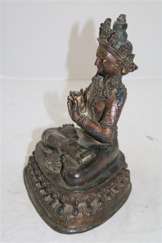 A Sino-Tibetan lacquered bronze seated figure of a Bodhisattva, 16th/17th century, height 23cm